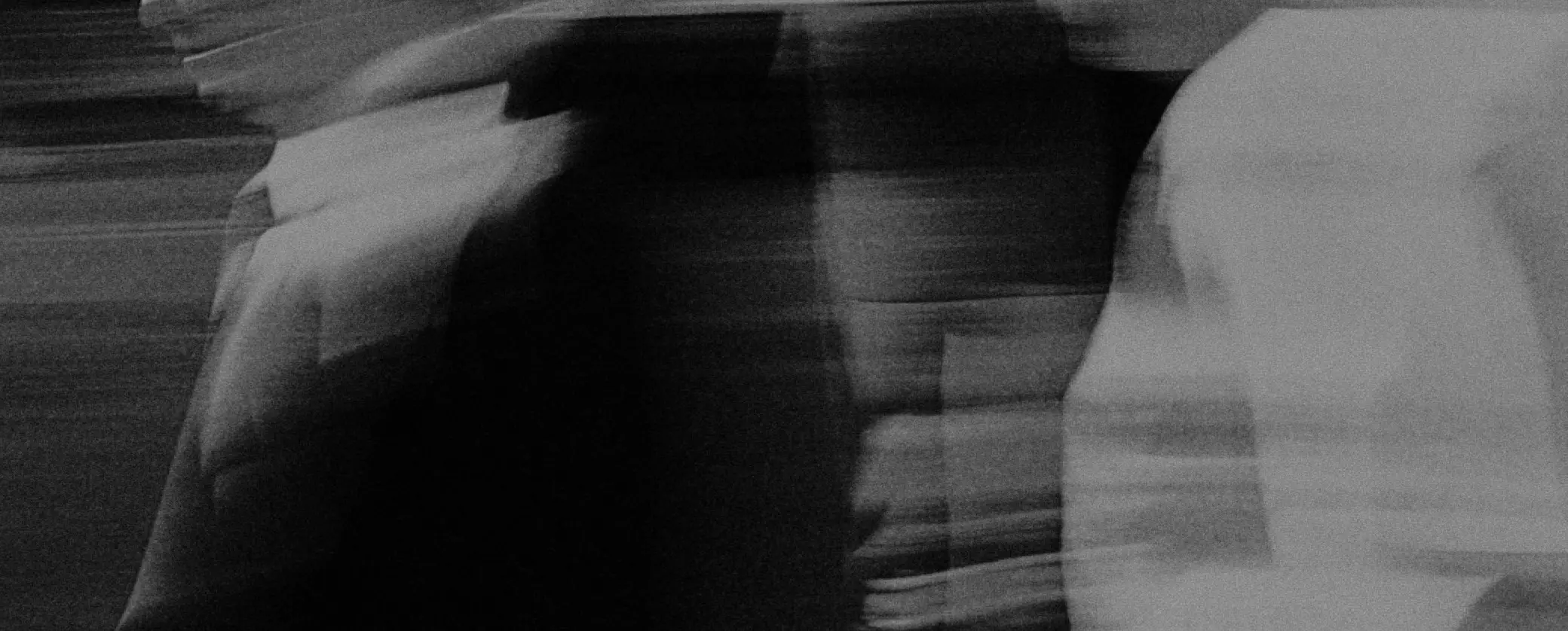 People in motion, photographed in black and white.